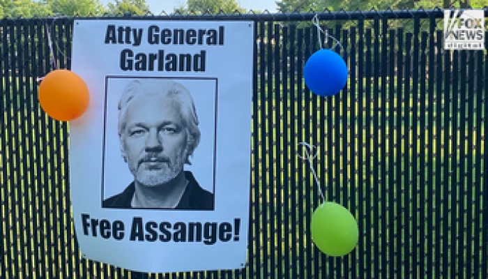 Supporters of Julian Assange gather outside Merrick Garland’s house to call for the dismissal of the charges.