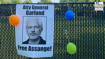 Supporters of Julian Assange gather outside Merrick Garland’s house to call for the dismissal of the charges.