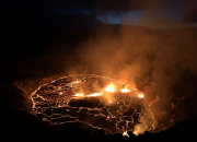 Hawaii’s Kilauea volcano spews lava fountains while a lagoon of molten rock illuminates the night.