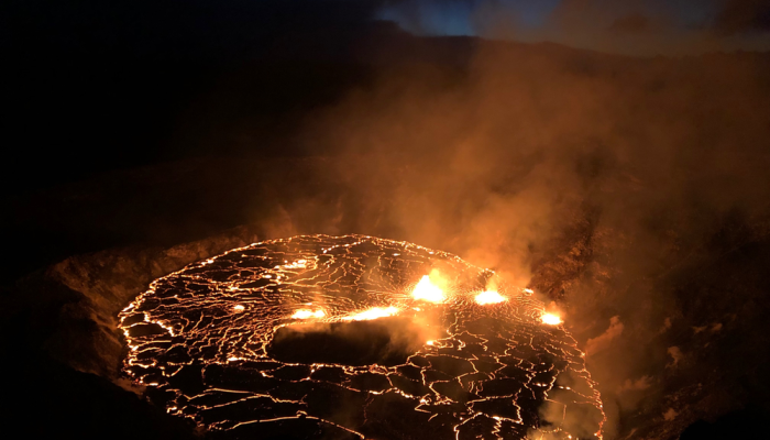 Hawaii’s Kilauea volcano spews lava fountains while a lagoon of molten rock illuminates the night.