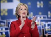 Social media users criticize Hillary Clinton’s new State Department photo, writing, “You should be in jail.”