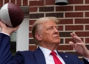 Donald Trump tailgates before the Iowa-Iowa State game, and the crowd erupts as he steps into the stadium.