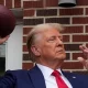 Donald Trump tailgates before the Iowa-Iowa State game, and the crowd erupts as he steps into the stadium.