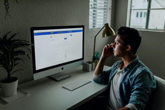 men work on computer